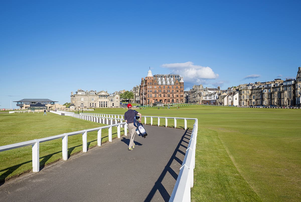 Golfer at the Home of Golf walking towards the Royal and Ancient Club House St Andrews Scotland